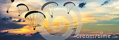 Silhouette Of Paragliders At Sunset Stock Photo