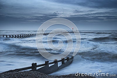 Beautiful dramatic stormy landscape image of waves crashing onto Stock Photo