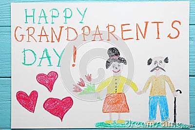 Beautiful drawing with phrase Happy Grandparents Day on blue wooden table, top view Stock Photo