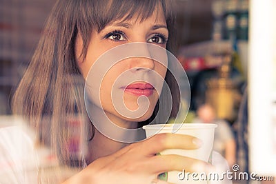 Beautiful dreaming young girl with cup of coffee Stock Photo