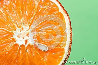 Beautiful dried orange with bone close-up on a light green background Stock Photo