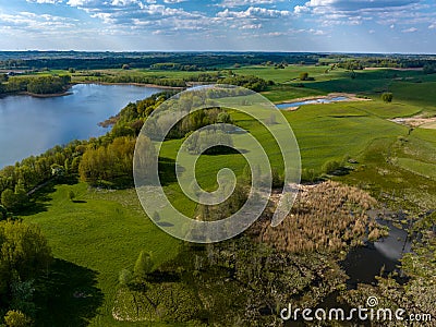 Beautiful drone nature landscape of fields, meadows, forest and lake - sunny day in Poland, Mazury Stock Photo