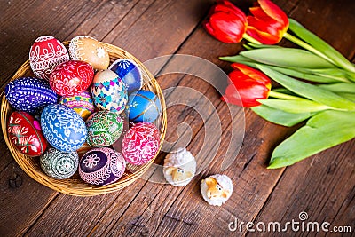 Easter eggs with tulips on weathered wooden background Stock Photo