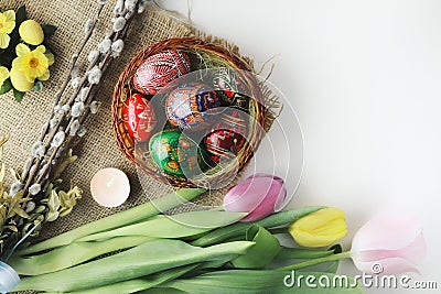 Beautiful Eastern style flat lay with traditional painted eggs and tulips Stock Photo