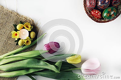 Beautiful Eastern style flat lay with traditional painted eggs and tulips Stock Photo