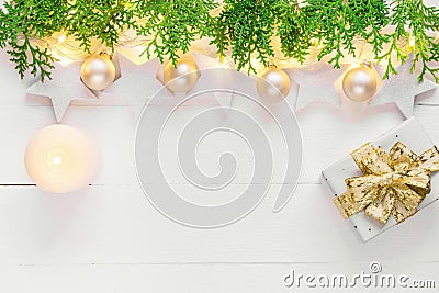 Beautiful elegant Christmas New Year background with stars sparkling golden lights garland balls green cypress gift box candle Stock Photo