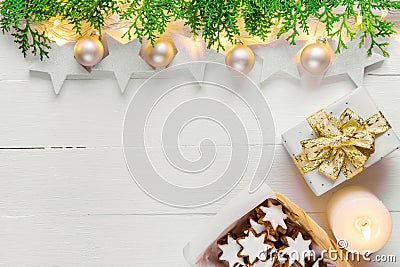 Beautiful elegant Christmas New Year background with stars sparkling golden lights garland balls green cypress gift boxes candle c Stock Photo