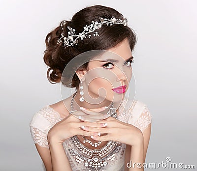 Beautiful elegant girl model with jewelry, makeup and retro hair styling. Manicured nails. Stock Photo