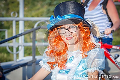 beautiful, elegant, ornate participant in the carnival costumed women`s bike ride in the summer evening Editorial Stock Photo