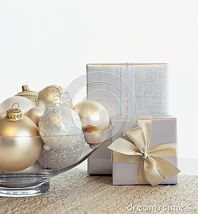 Beautiful, elegant silver and gold Christmas gifts and glass bowl with baubles ornaments. Fancy, luxury holiday home decor Stock Photo