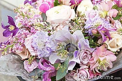Beautiful pink purple violet bouquet by florist with different flowers and roses close-up, macro. Floral background Stock Photo