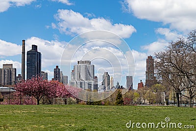 An Empty Grass Field at Rainey Park during Spring in Astoria Queens New York with the Roosevelt Island and Upper East Side Skyline Stock Photo