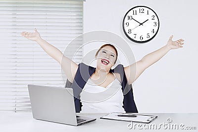 Beautiful entrepreneur lifting hands in office Stock Photo