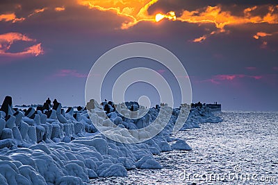 A beautiful evening landscape of a frozen breakwater in the Baltic sea. Winter landscape at the beach. Editorial Stock Photo