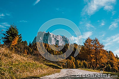 Road going toward high mountain as a symbol of challenge in dolomites epic landscape in sunny day Stock Photo
