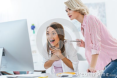 beautiful excited girls working with computer Stock Photo