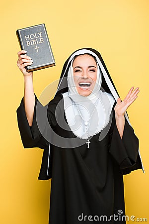 Beautiful excited nun holding holy bible Stock Photo