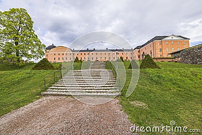 Beautiful exterior of Royal Palace with green lawn and staircase leading up to building in foreground. Stock Photo