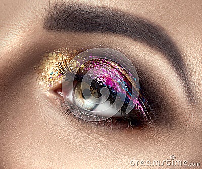 Beautiful Eye Make-up with colorful sparks. Beauty bright fashion holiday smoky eye makeup. Make up sample Stock Photo