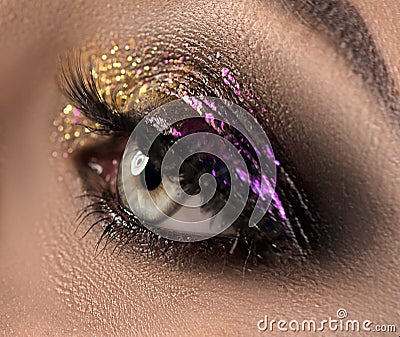 Beautiful eye makeup with colorful sparks. Beauty bright fashion holiday smoky eyes makeup Stock Photo