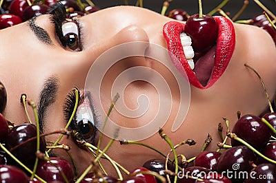 Beautiful face in cherry closeup Stock Photo