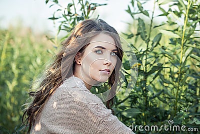 Beautiful face. Cute young woman relaxing on greenery foliage background Stock Photo