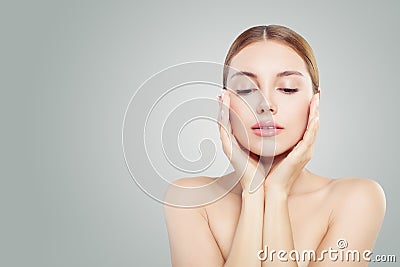 Beautiful face. Pretty woman holding her face in her hands. Facial treatment, face lifting, anti aging and skin care concept Stock Photo