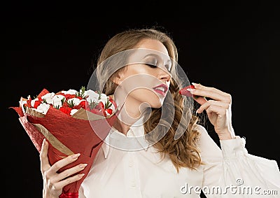 Face, red lips, strawberry, marshmallows, black background Stock Photo