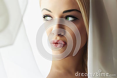 Beautiful Face of Young Blond Bride Woman. Girl Look in Window.Bridal Veil. Curtains Stock Photo