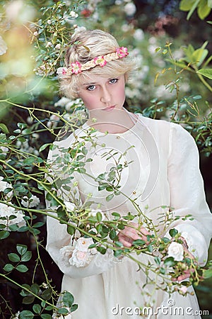 Beautiful fairy girl in roses garden Stock Photo