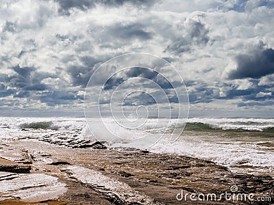 Beautiful Fanore beach, Yellow sand, blue water and cloudy sky, Waves rushing towards the coast, County Clare, Ireland Stock Photo