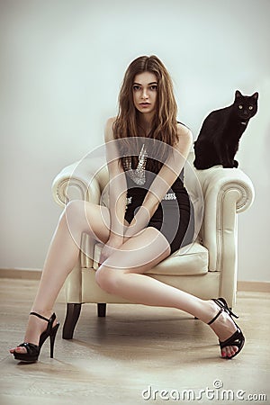 Beautiful fashion model woman with a cat Stock Photo