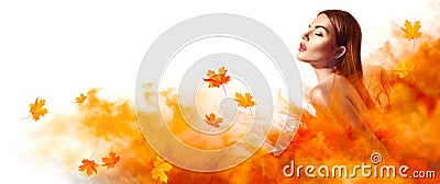 Beautiful fashion woman in autumn yellow dress with falling leaves Stock Photo