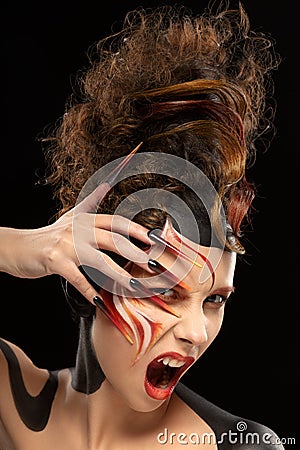 Beautiful fashion woman color face art fenix style and nail design Stock Photo