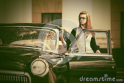 Beautiful fashion woman next to retro car Stock Photo