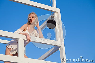 Beautiful fashionable blonde woman lifeguard on the beach by the sea Stock Photo