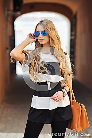Beautiful fashionable woman with long blonde hair, outdoors shot Stock Photo