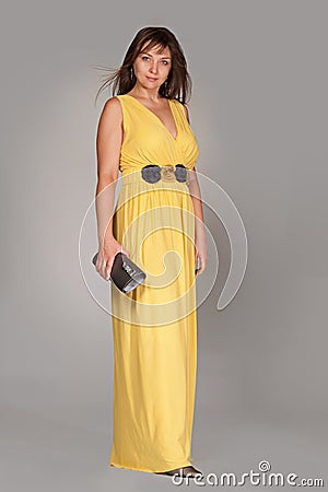 Beautiful fashionable woman in long yellow dress. Stock Photo