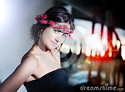 Beautiful fashionable young woman with city lights background Stock Photo