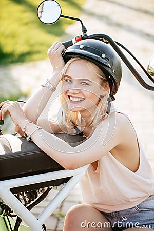 Woman wearing biking helmet. Close-up portrait of female cyclist in park. Stock Photo