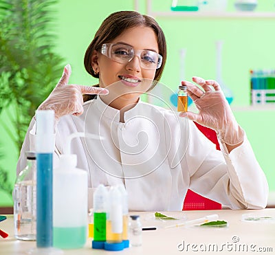 Beautiful female biotechnology scientist chemist working in lab Stock Photo