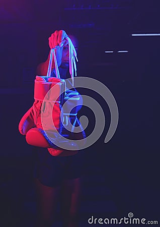 Red boxing gloves, ring with red and blue lights, industrial gym. selective focus Stock Photo