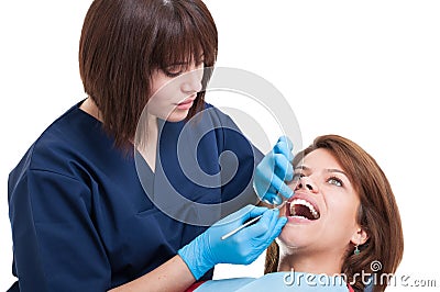 Beautiful female dentist performing oral exam Stock Photo