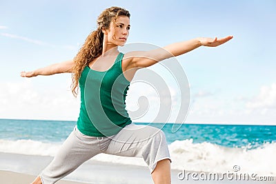 Beautiful female doing yoga warrior pose Stock Photo