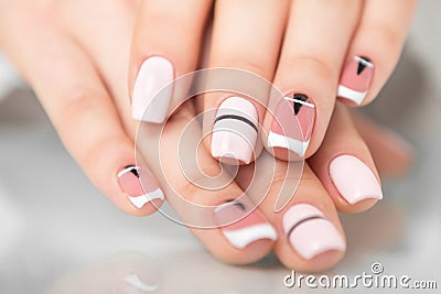 Beautiful female hands with a fashionable manicure. Geometric design of nails Stock Photo