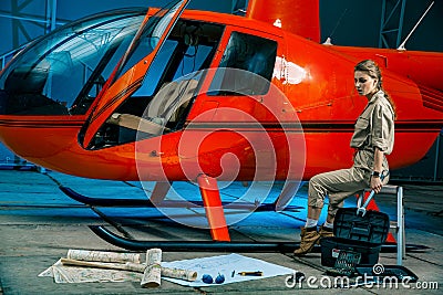 Beautiful female helicopter mechanic at work. feminism Stock Photo