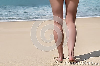 Beautiful female legs on beach, sand and sea at background Stock Photo