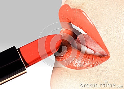 Beautiful female lips with fashion make-up. Trend light coral color. Makeup, visage and cosmetics. Choice lipstick Stock Photo