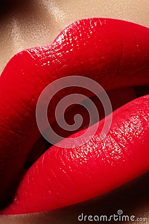 Beautiful female Lips. Sweet Kiss with red lipstick. Lip Make-up on macro shoot. Hot fashion lip makeup Stock Photo