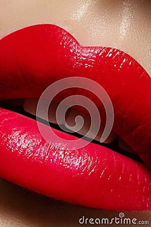 Beautiful female Lips. Sweet Kiss with red lipstick. Lip Make-up on macro shoot. Hot fashion lip makeup Stock Photo